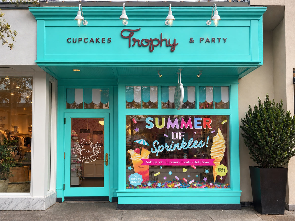 Trophy Cupcakes & Party storefront at University Village, painted aqua with the Trophy sign