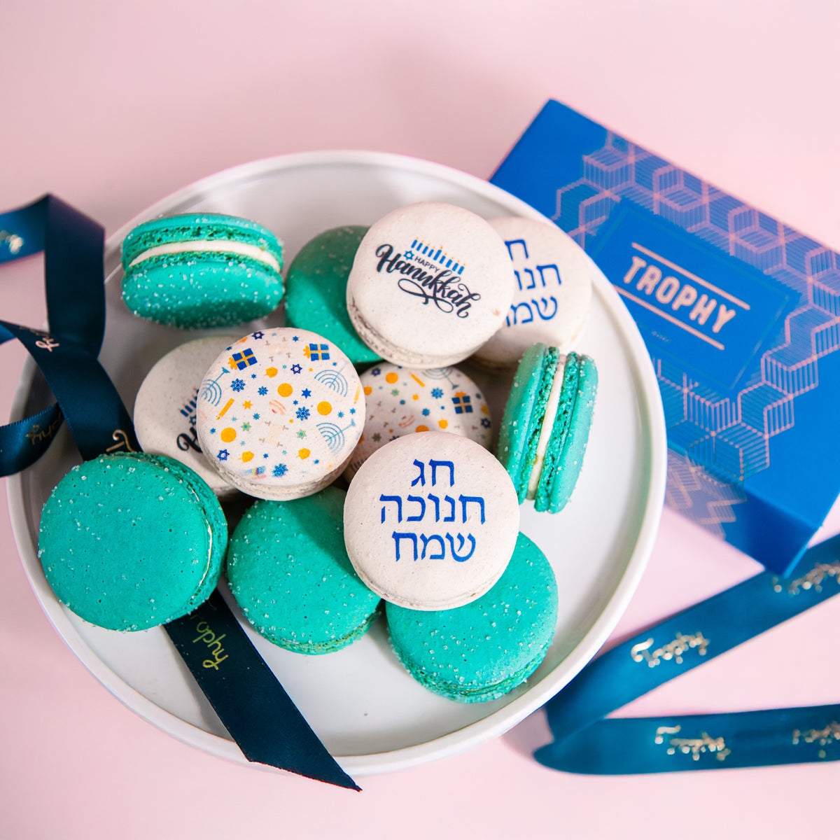 Macarons printed for Hanukkah beside a Trophy gift box