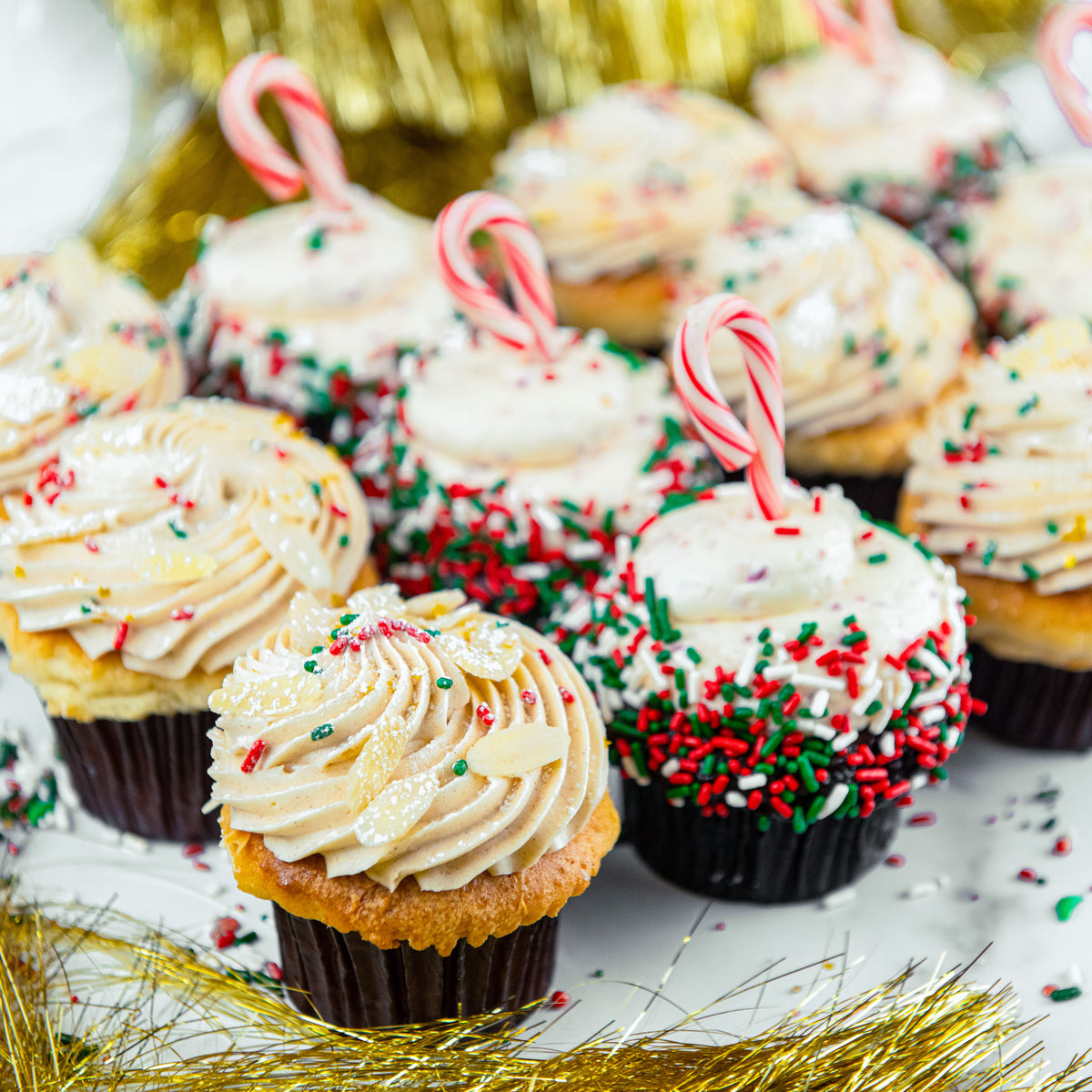 Trophy Christmas cupcakes topped with candy canes and festive sprinkles