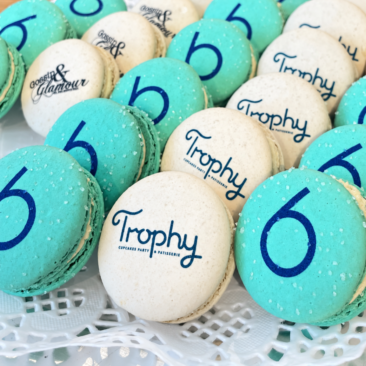Blue and white Trophy macarons printed with a custom logo and the number 6