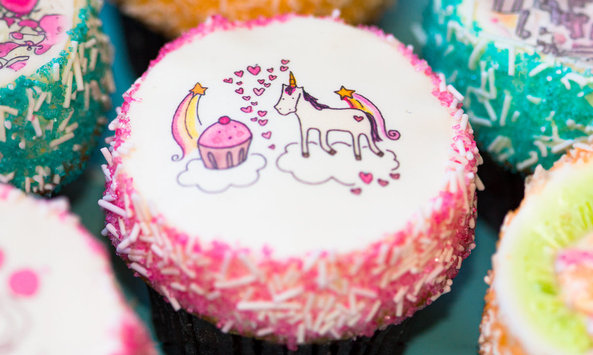 Cupcakes topped with a child’s colorful drawing printed as an edible image