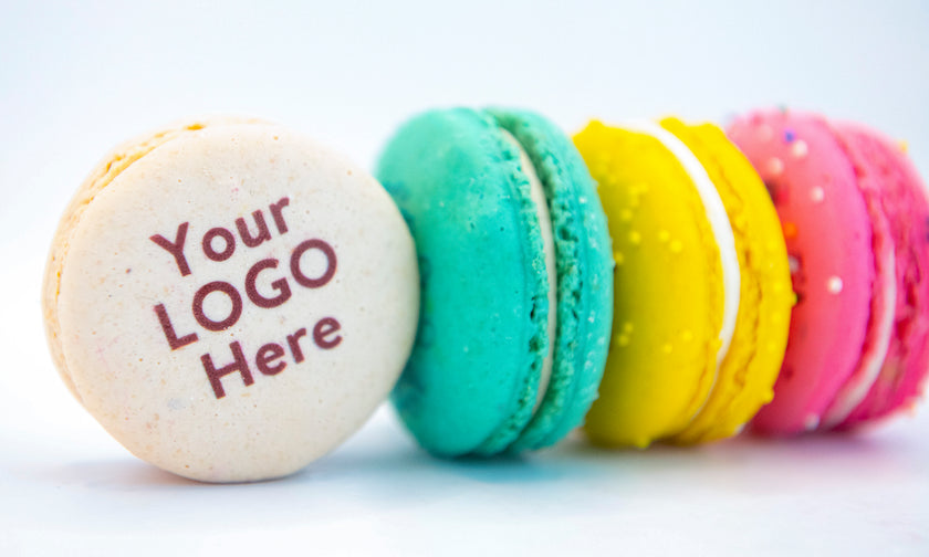 A row of colorful Trophy macarons, the front one printed with “Your LOGO Here”