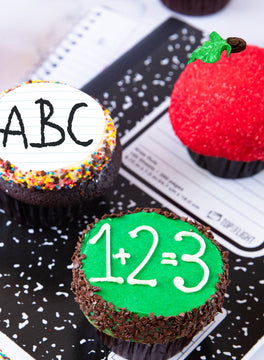 Cupcakes decorated as an ABC notebook page, a red apple and a 1+2=3 chalkboard on a composition notebook