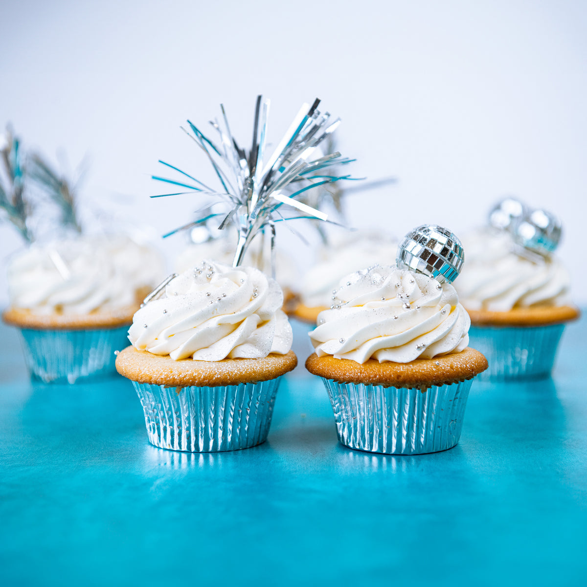 Trophy New Year's cupcakes with silver tinsel toppers